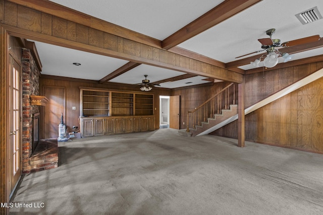 160 Marblehead Ct, Jackson, MS 39211 - unfurnished living room with ceiling fan, wooden walls, a brick fireplace, stairs, and beam ceiling