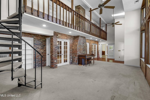 160 Marblehead Ct, Jackson, MS 39211 - carpeted living area featuring a high ceiling, french doors, a ceiling fan, brick wall, and stairs