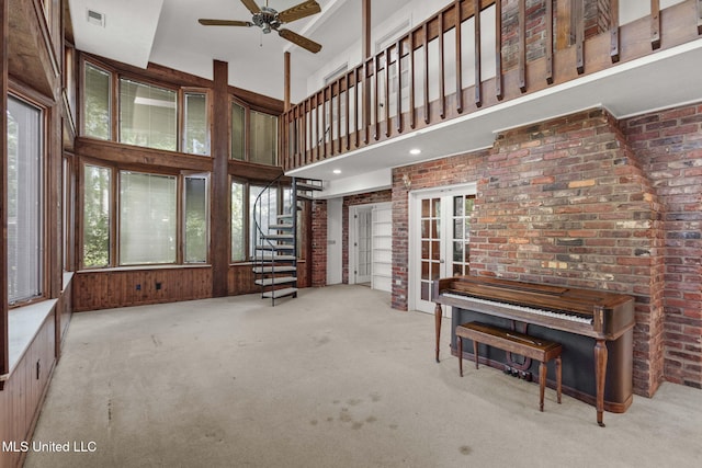 160 Marblehead Ct, Jackson, MS 39211 - carpeted living area with ceiling fan, a towering ceiling, stairs, and brick wall