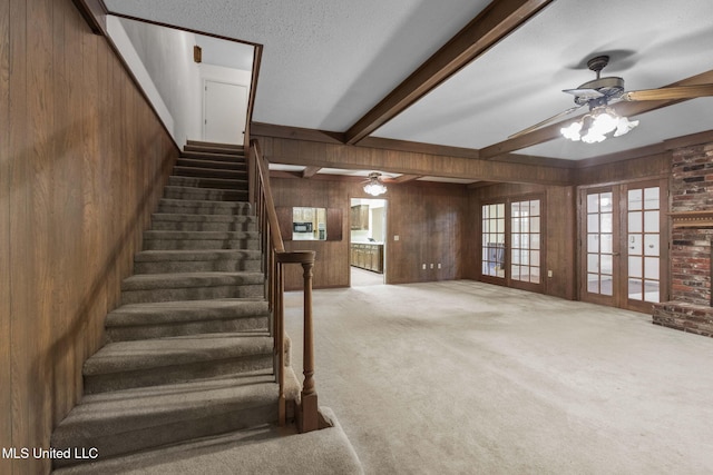 160 Marblehead Ct, Jackson, MS 39211 - staircase featuring ceiling fan, wooden walls, carpet, beamed ceiling, and french doors