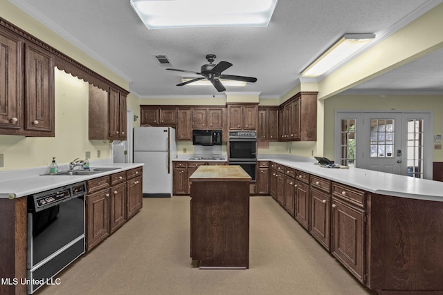160 Marblehead Ct, Jackson, MS 39211 - kitchen with black appliances, a kitchen island, crown molding, light countertops, and a peninsula