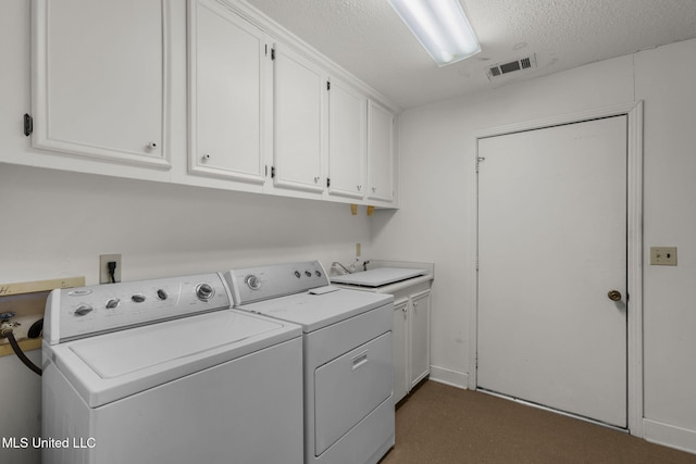 160 Marblehead Ct, Jackson, MS 39211 - laundry area with separate washer and dryer, cabinet space, and a textured ceiling