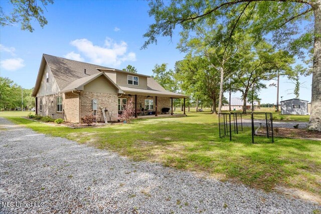 24023 Robert E Lee Rd, Lucedale, MS 39452 - view of front facade with gravel driveway, a front yard, and brick siding