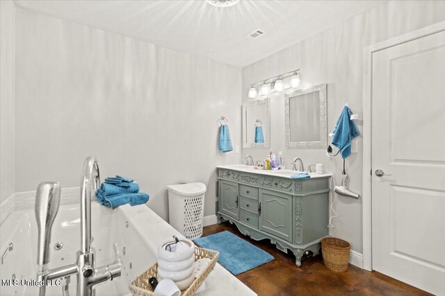 24023 Robert E Lee Rd, Lucedale, MS 39452 - full bathroom with finished concrete floors, a sink, double vanity, visible vents, and a jetted tub