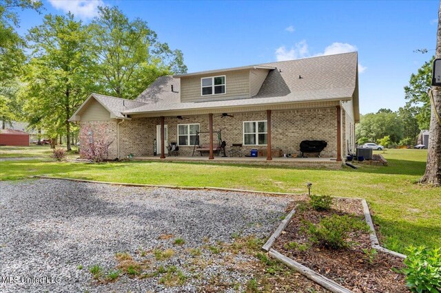 24023 Robert E Lee Rd, Lucedale, MS 39452 - back of house with central AC, a patio, a yard, a ceiling fan, and brick siding