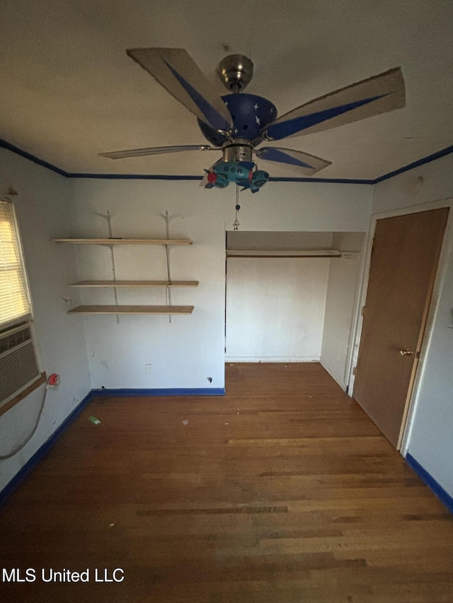 unfurnished bedroom featuring ornamental molding and dark wood finished floors