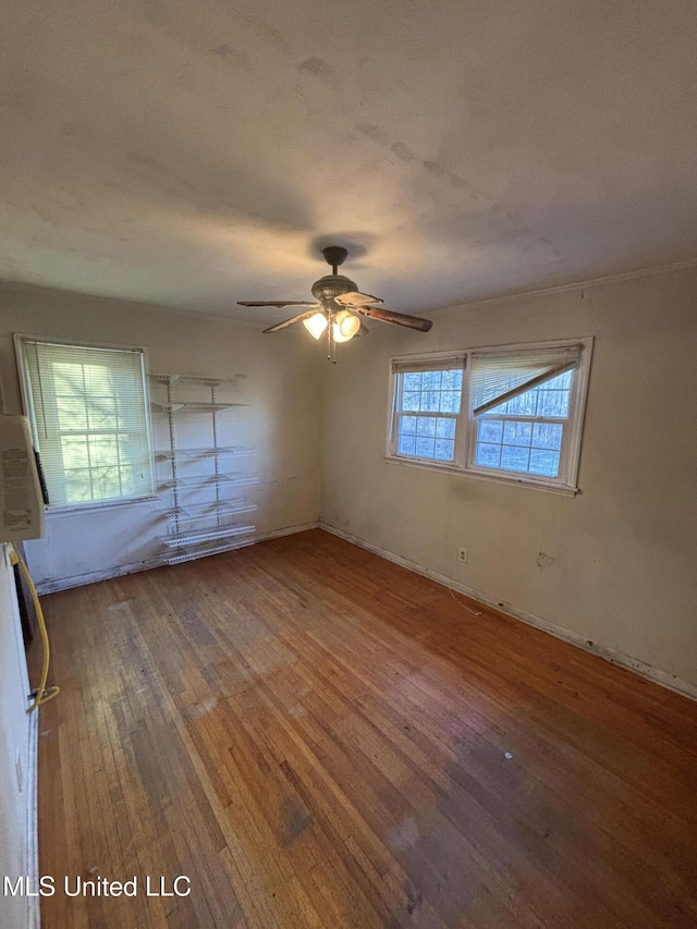 interior space with wood-type flooring and ceiling fan