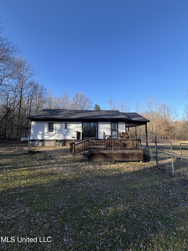 view of front facade featuring a wooden deck and fence