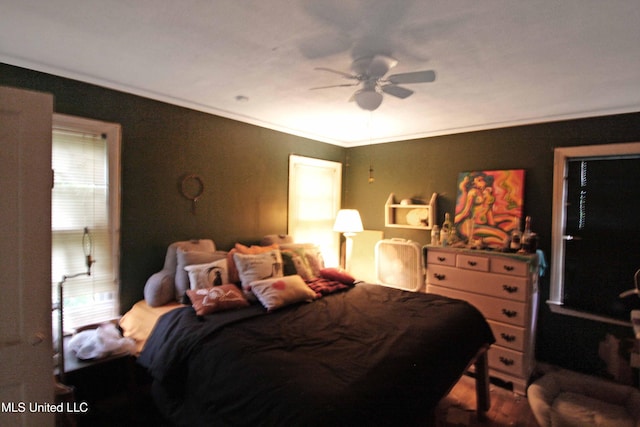 bedroom with ceiling fan and ornamental molding