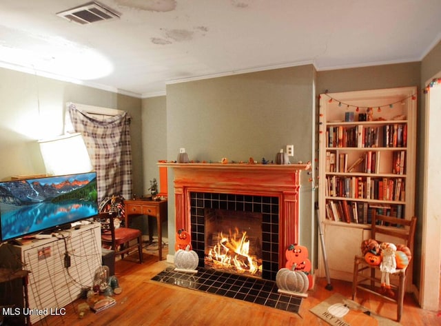 4803 Sheridan Dr, Jackson, MS 39206 - living area featuring ornamental molding, wood finished floors, and a tile fireplace