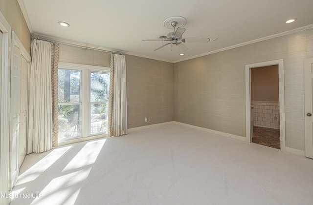 carpeted spare room featuring ornamental molding, recessed lighting, baseboards, and a ceiling fan