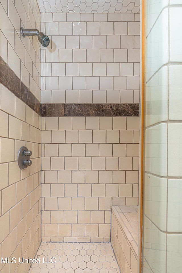 full bath with a tile shower