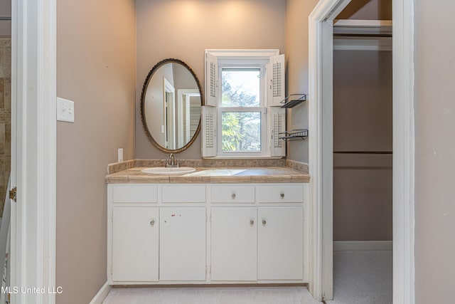 bathroom featuring vanity and baseboards