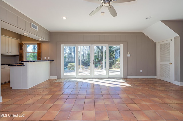 unfurnished living room featuring light tile patterned floors, lofted ceiling, recessed lighting, visible vents, and a ceiling fan