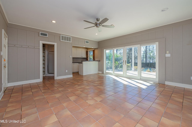 unfurnished living room featuring a ceiling fan, visible vents, and light tile patterned floors