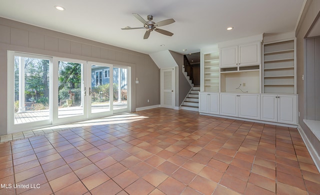 unfurnished living room featuring built in shelves, light tile patterned floors, recessed lighting, stairway, and a ceiling fan