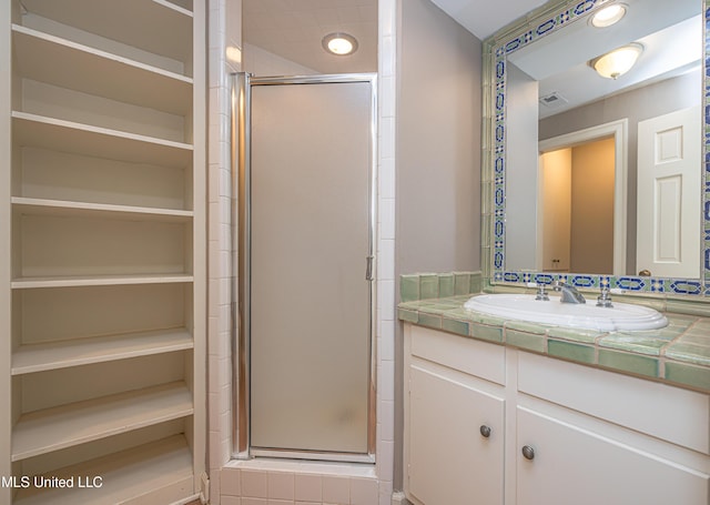 bathroom featuring a stall shower, visible vents, and vanity