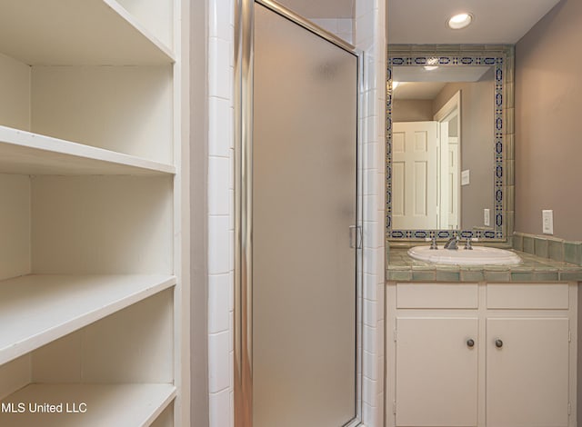 bathroom featuring recessed lighting, a shower stall, and vanity