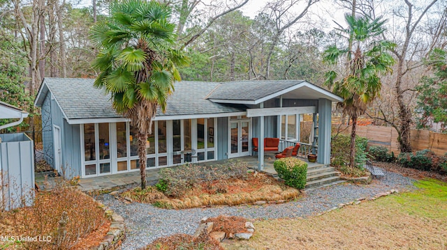 view of front of property with french doors and fence