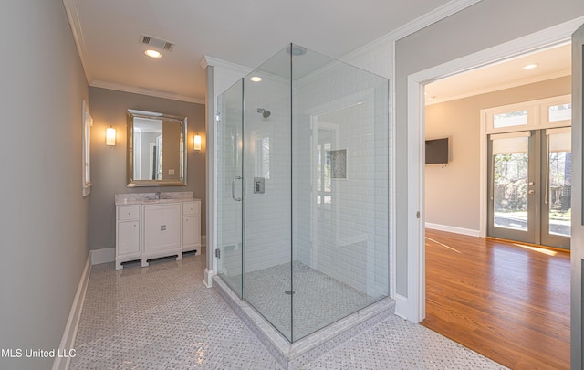 bathroom with a shower stall, visible vents, ornamental molding, and french doors