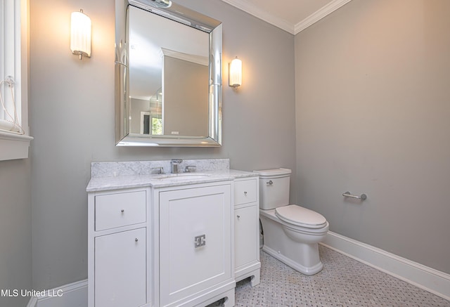 bathroom with toilet, vanity, baseboards, tile patterned floors, and crown molding