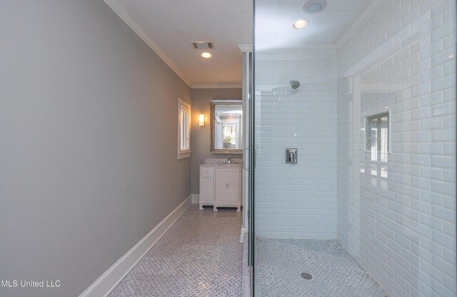 bathroom with a stall shower, visible vents, crown molding, and baseboards