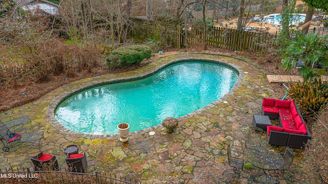 view of pool featuring fence, a fenced in pool, and a patio