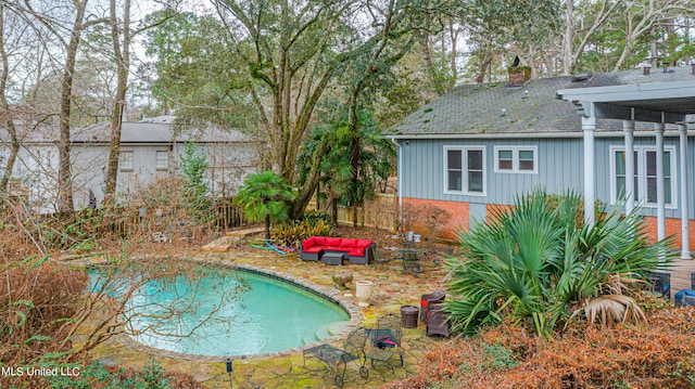 view of pool featuring outdoor lounge area and a patio