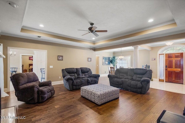 108 Merlot Cv, Clinton, MS 39056 - living room with a tray ceiling, a chandelier, ceiling fan, crown molding, and wood finished floors