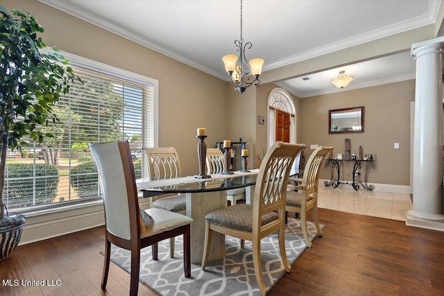 108 Merlot Cv, Clinton, MS 39056 - dining room with decorative columns, crown molding, wood finished floors, baseboards, and a chandelier