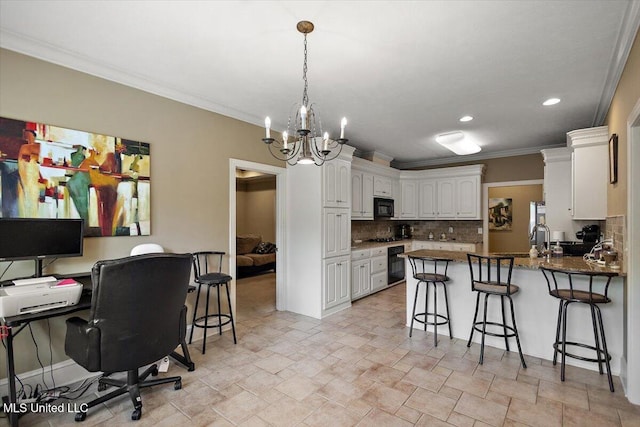 108 Merlot Cv, Clinton, MS 39056 - kitchen featuring a peninsula, black microwave, a chandelier, backsplash, and white cabinets