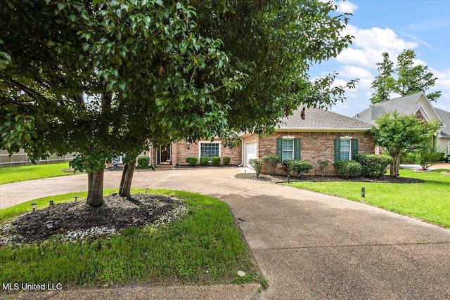 108 Merlot Cv, Clinton, MS 39056 - obstructed view of property featuring curved driveway, brick siding, a front lawn, a garage, and roof with shingles