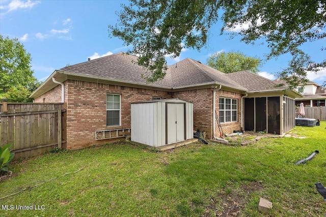 108 Merlot Cv, Clinton, MS 39056 - back of house with brick siding, roof with shingles, a storage shed, and a sunroom