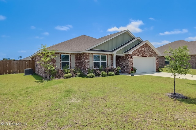 craftsman-style home featuring a front yard, a garage, and central air condition unit