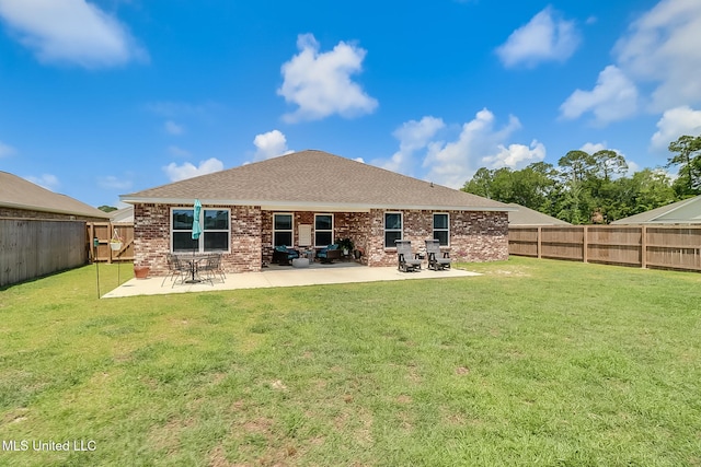 rear view of property featuring a yard and a patio