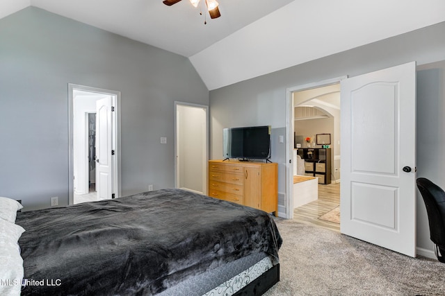 9821 Morgan Manor Dr, Olive Branch, MS 38654 - bedroom with vaulted ceiling, arched walkways, light colored carpet, and a ceiling fan