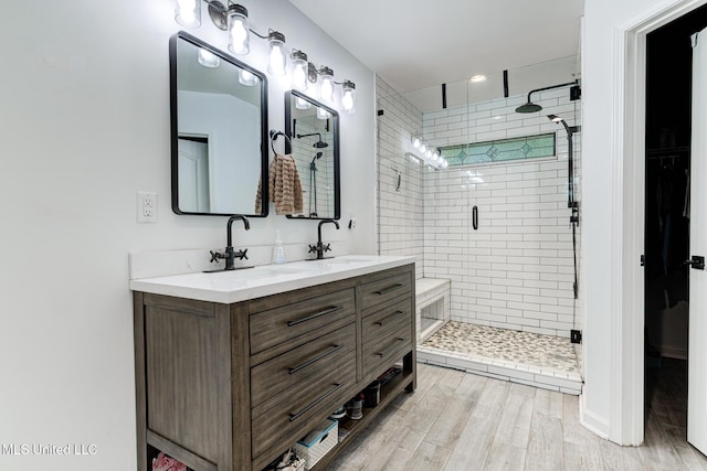 9821 Morgan Manor Dr, Olive Branch, MS 38654 - bathroom featuring double vanity, a stall shower, and wood finished floors