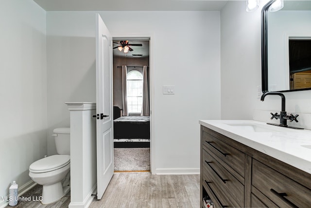 9821 Morgan Manor Dr, Olive Branch, MS 38654 - bathroom with wood finished floors, double vanity, and ceiling fan