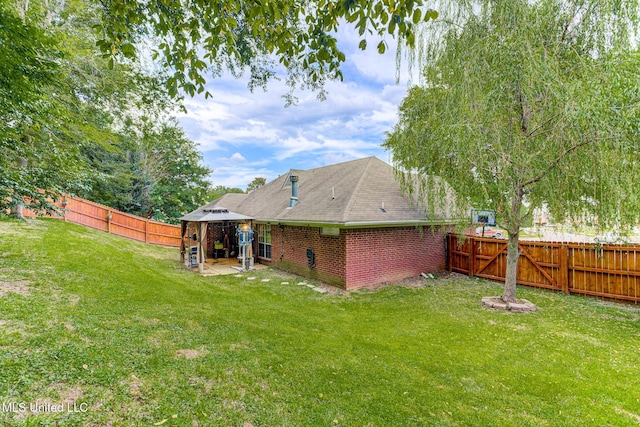 9821 Morgan Manor Dr, Olive Branch, MS 38654 - back of house featuring a gazebo, a fenced backyard, and brick siding