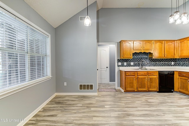 9821 Morgan Manor Dr, Olive Branch, MS 38654 - kitchen featuring dishwasher, light countertops, light wood-type flooring, pendant lighting, and high vaulted ceiling