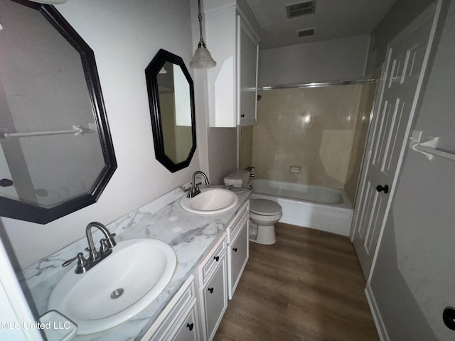 full bathroom featuring vanity, toilet, tub / shower combination, and hardwood / wood-style floors