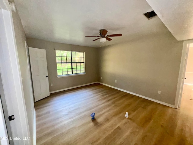 empty room featuring wood-type flooring and ceiling fan