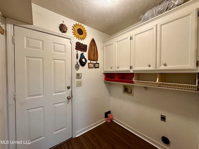 clothes washing area with a textured ceiling, dark wood-type flooring, electric dryer hookup, washer hookup, and cabinets