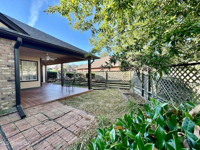 view of yard featuring a patio area and ceiling fan