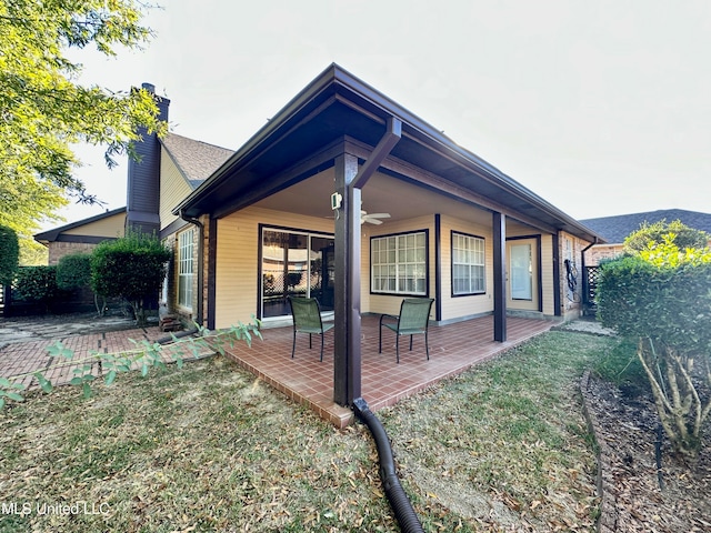 view of home's exterior with a patio area and ceiling fan