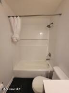 full bathroom with shower / bath combination with curtain, toilet, and vanity