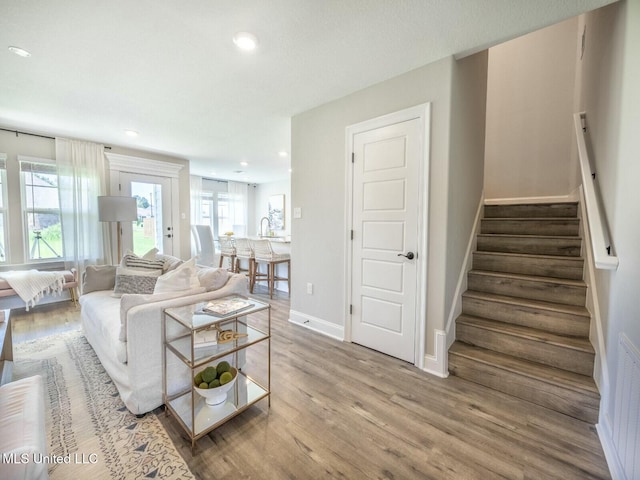 9626 W Oaklawn Rd, Biloxi, MS 39532 - living area featuring wood finished floors, recessed lighting, and stairway