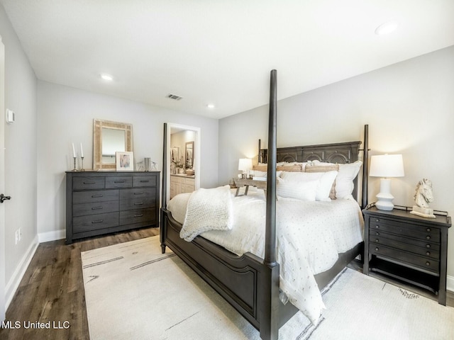 9626 W Oaklawn Rd, Biloxi, MS 39532 - bedroom with wood finished floors, connected bathroom, and recessed lighting