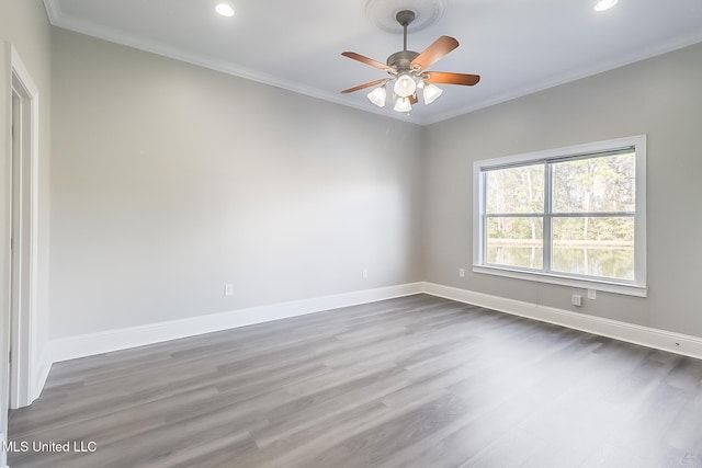 spare room with ceiling fan, crown molding, and dark hardwood / wood-style flooring