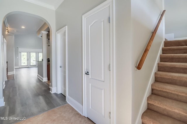 hallway featuring ornamental molding, french doors, and light tile patterned flooring